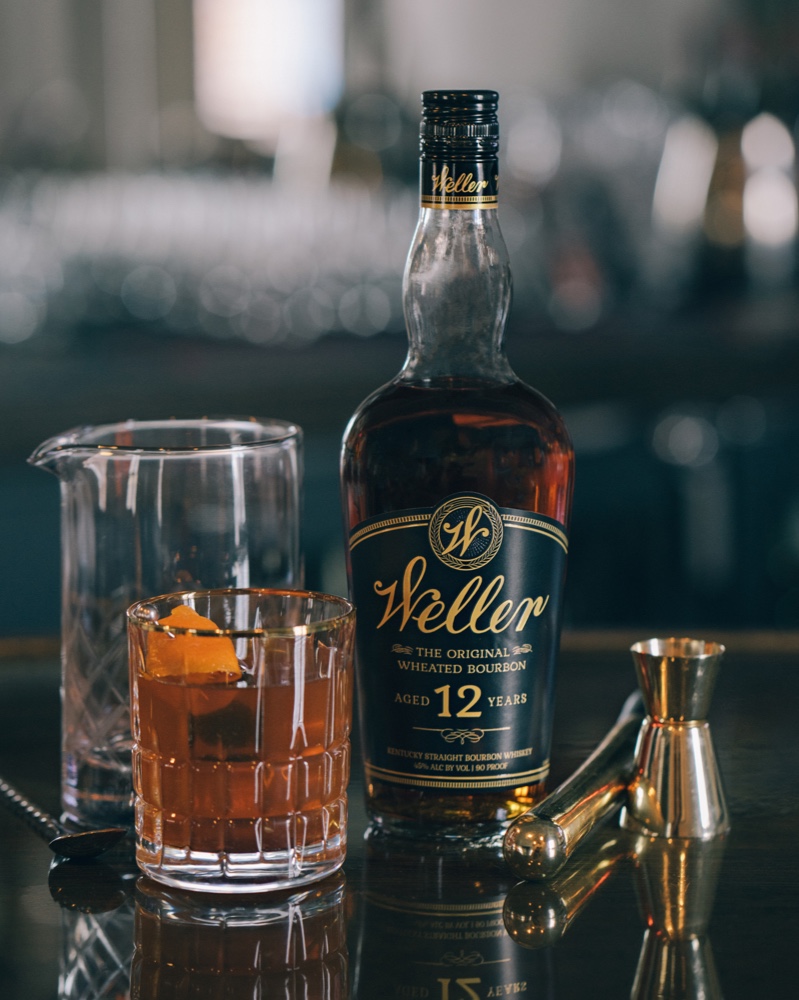 A custom drink made with Weller Aged 12 Years and garnished with a Orange slice