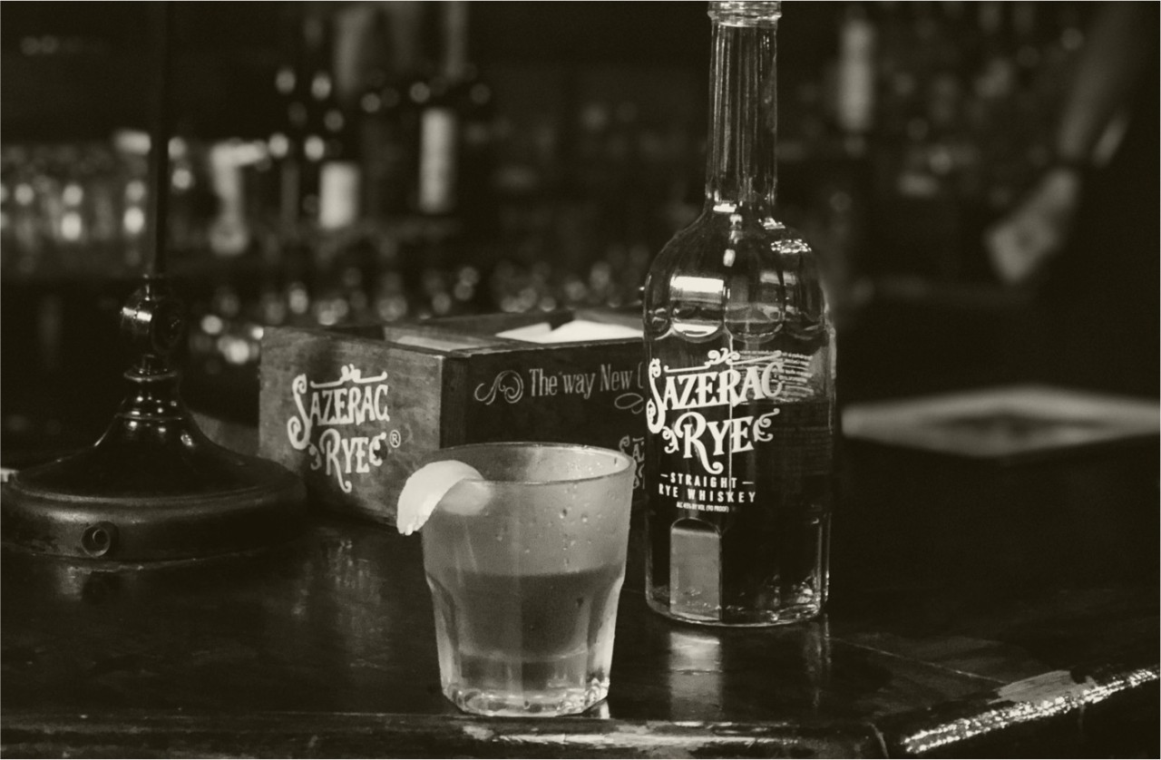 A black and white photo of a cocktail made with Sazerac Rye with lemon to garnish